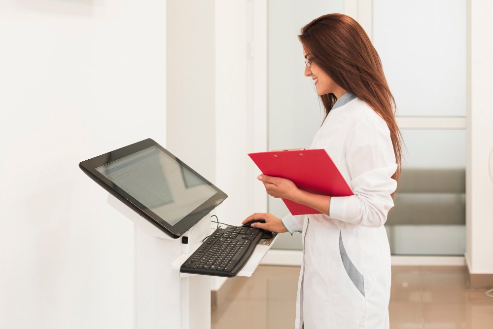 doctor-holding-clipboard-working-computer